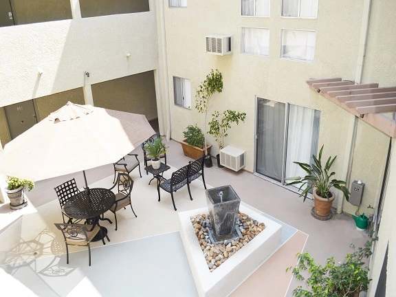 Inviting courtyard with seating area and fountain at Valley Apartments in Pasadena, California.